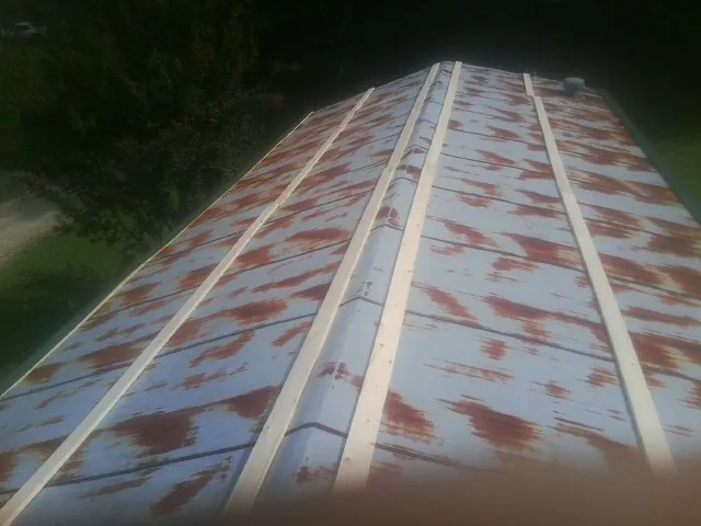 Rusted metal roof panels with new wood purlins before replacement — Storm Damage Roof Repair in New Lenox by Roofing Brothers