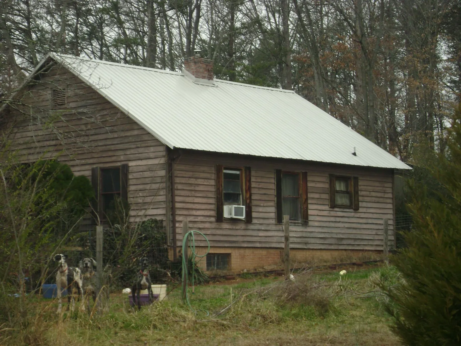 White metal roof on an old wood sided farmhouse, from a Asphalt Shingle Roof Repair job in New Lenox